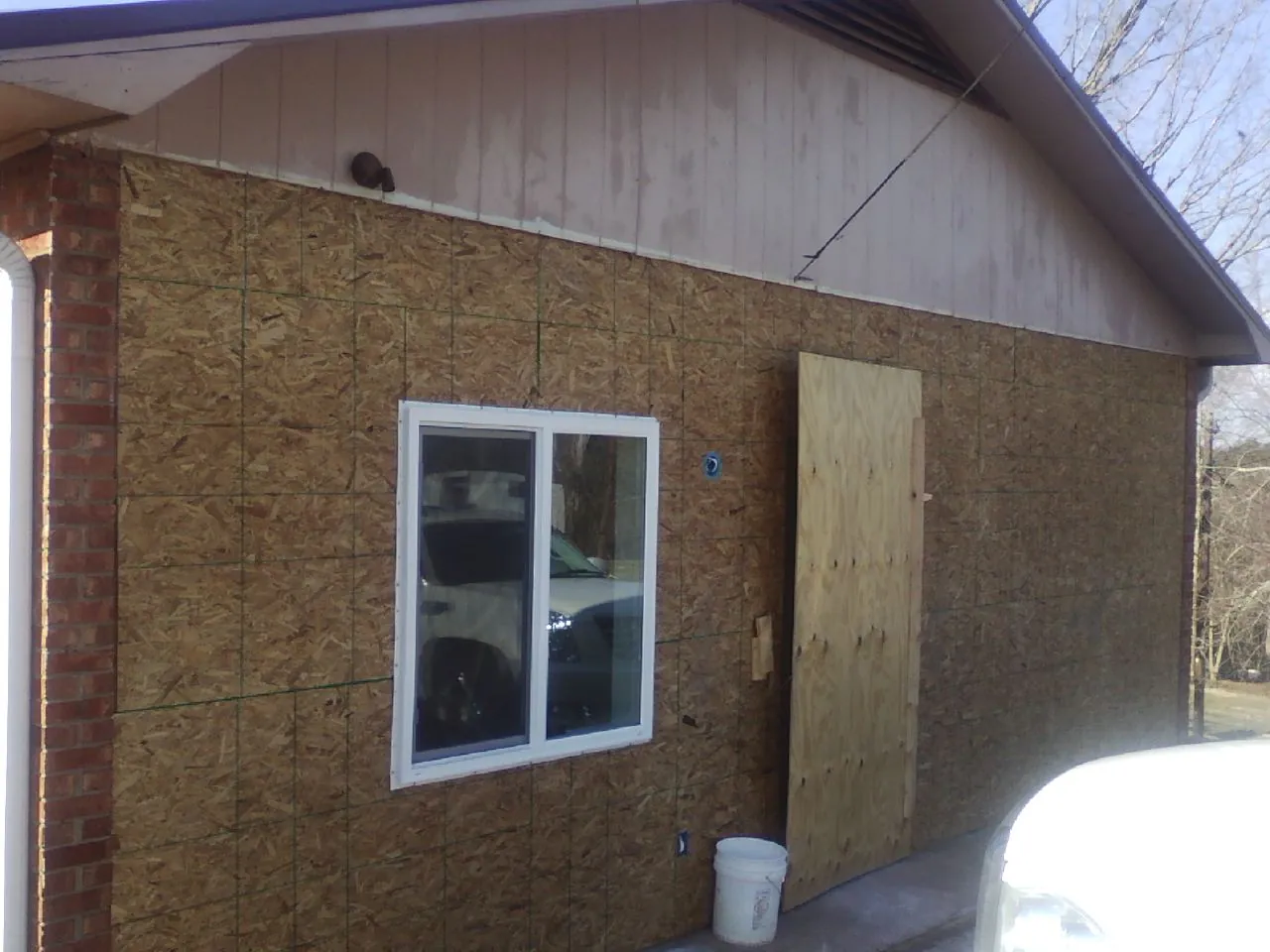 OSB sheathing on a garage addition wall before siding in Rye